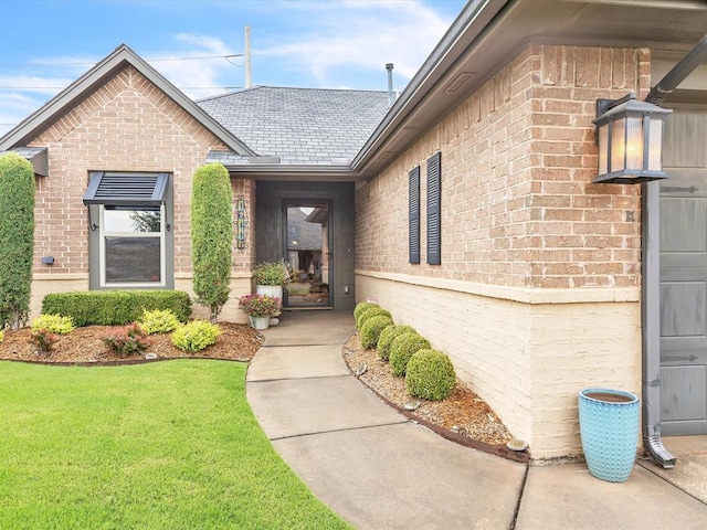16117 Cale Dr, Edmond, OK 73013 - doorway to property with brick siding and a lawn