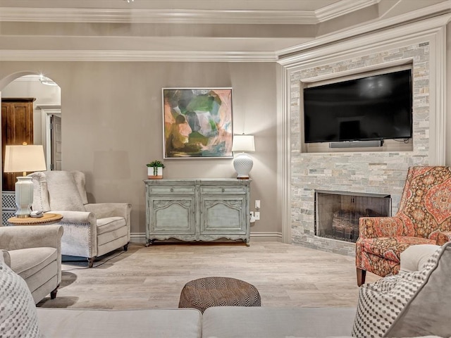 16117 Cale Dr, Edmond, OK 73013 - living area featuring light wood-style floors, arched walkways, ornamental molding, and a fireplace