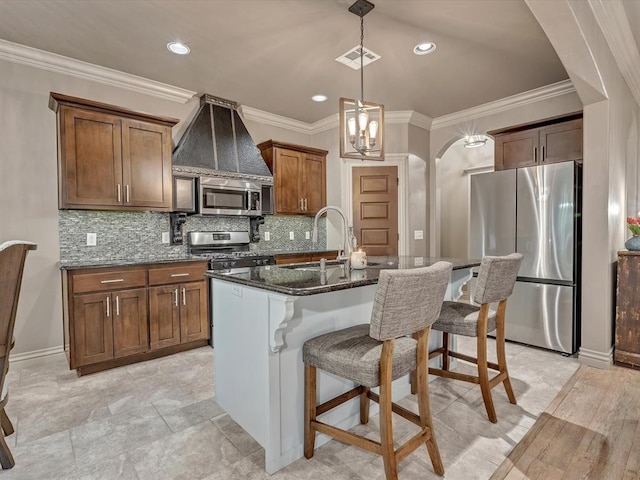 16117 Cale Dr, Edmond, OK 73013 - kitchen with appliances with stainless steel finishes, dark stone countertops, a breakfast bar, decorative backsplash, and arched walkways