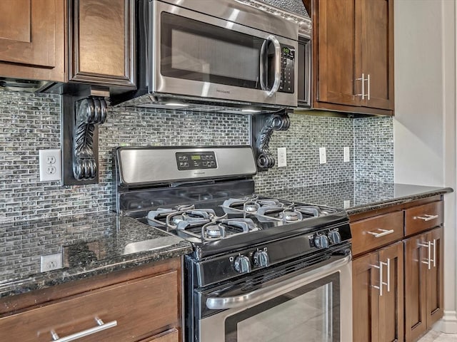 16117 Cale Dr, Edmond, OK 73013 - kitchen with appliances with stainless steel finishes, tasteful backsplash, and dark stone counters