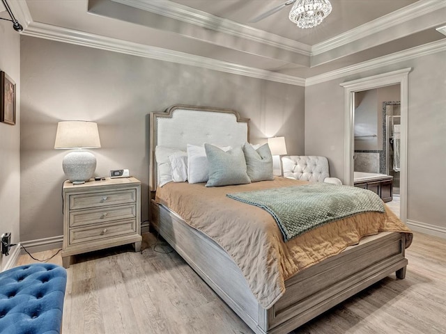 16117 Cale Dr, Edmond, OK 73013 - bedroom with a tray ceiling, light wood-type flooring, ornamental molding, and a chandelier