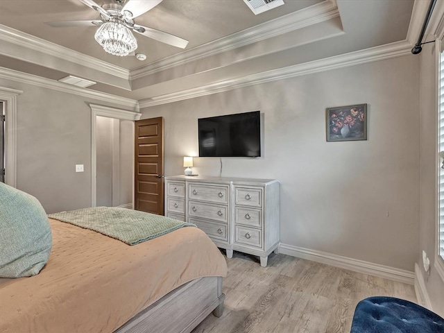 16117 Cale Dr, Edmond, OK 73013 - bedroom featuring a tray ceiling, light wood-style flooring, ceiling fan, and ornamental molding