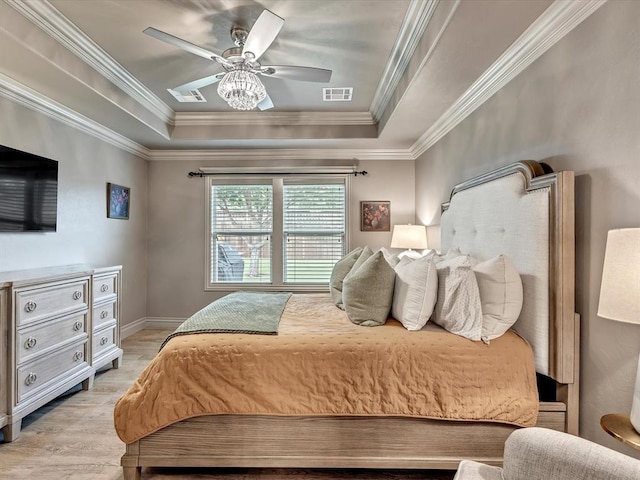 16117 Cale Dr, Edmond, OK 73013 - bedroom featuring a tray ceiling, light wood-style floors, ornamental molding, and a ceiling fan