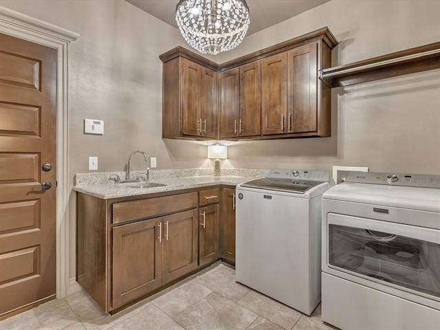 16117 Cale Dr, Edmond, OK 73013 - laundry area with separate washer and dryer, cabinet space, a chandelier, and light tile patterned floors