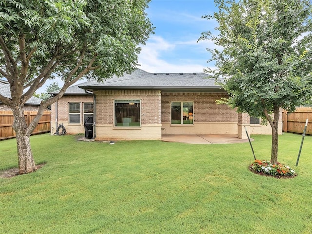 16117 Cale Dr, Edmond, OK 73013 - back of house with brick siding, a fenced backyard, a patio, and roof with shingles