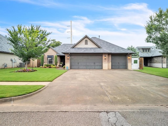 16117 Cale Dr, Edmond, OK 73013 - view of front facade featuring brick siding, a garage, concrete driveway, and a gate