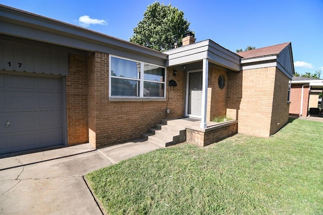 4117 NW 21st St, Oklahoma City, OK 73107 - view of exterior entry featuring brick siding, a lawn, a chimney, and an attached garage