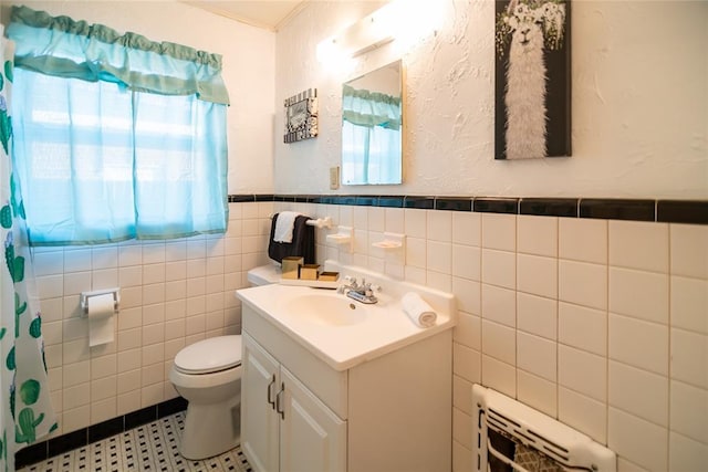 4117 NW 21st St, Oklahoma City, OK 73107 - full bathroom with vanity, tile walls, heating unit, wainscoting, and tile patterned flooring