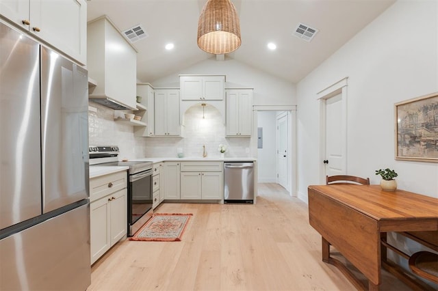406 E Logan Ave, Guthrie, OK 73044 - kitchen featuring stainless steel appliances, light countertops, light wood finished floors, tasteful backsplash, and vaulted ceiling