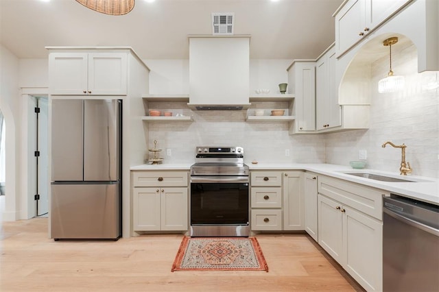 406 E Logan Ave, Guthrie, OK 73044 - kitchen with stainless steel appliances, open shelves, and decorative backsplash