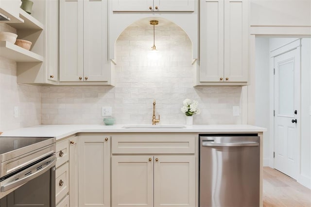 406 E Logan Ave, Guthrie, OK 73044 - kitchen featuring appliances with stainless steel finishes, light countertops, backsplash, light wood-type flooring, and open shelves