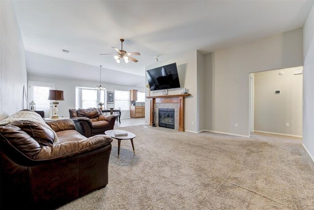 21854 Meadow Mist Cir, Edmond, OK 73012 - living room featuring ceiling fan, light carpet, lofted ceiling, and a tiled fireplace