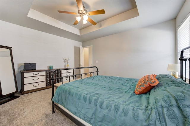 21854 Meadow Mist Cir, Edmond, OK 73012 - bedroom featuring carpet, a raised ceiling, and a ceiling fan