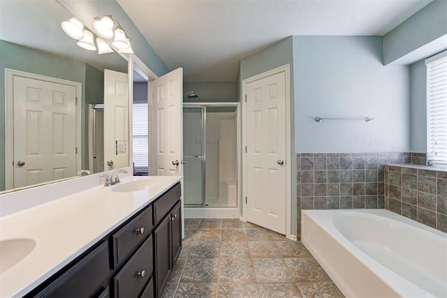 21854 Meadow Mist Cir, Edmond, OK 73012 - bathroom featuring a bath, a stall shower, and double vanity