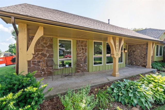 3425 Cheyenne Dr, Edmond, OK 73013 - rear view of house featuring stone siding and a shingled roof