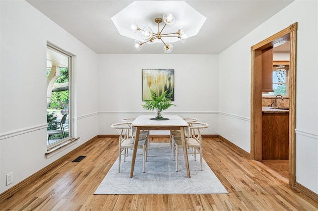 3425 Cheyenne Dr, Edmond, OK 73013 - dining area with light wood finished floors and a chandelier