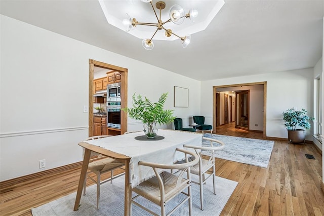 3425 Cheyenne Dr, Edmond, OK 73013 - dining area featuring a chandelier and light wood finished floors
