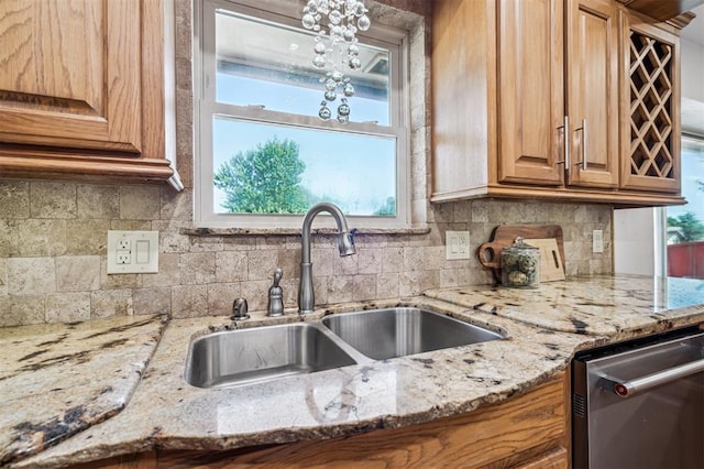 3425 Cheyenne Dr, Edmond, OK 73013 - kitchen with stainless steel dishwasher, backsplash, light stone counters, and healthy amount of natural light