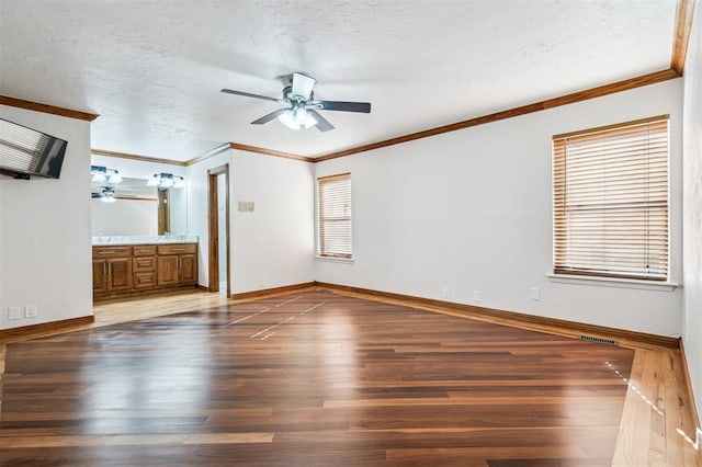 3425 Cheyenne Dr, Edmond, OK 73013 - unfurnished bedroom featuring wood finished floors, ornamental molding, a textured ceiling, ensuite bathroom, and ceiling fan