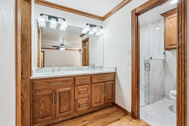 3425 Cheyenne Dr, Edmond, OK 73013 - full bath with ornamental molding, a marble finish shower, double vanity, wood finished floors, and ceiling fan