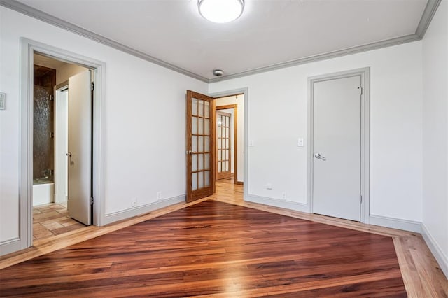 3425 Cheyenne Dr, Edmond, OK 73013 - unfurnished bedroom featuring wood finished floors, crown molding, and connected bathroom