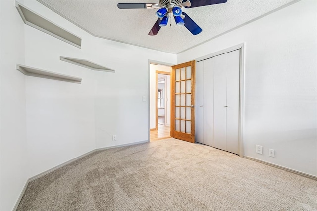 3425 Cheyenne Dr, Edmond, OK 73013 - unfurnished bedroom with carpet, a textured ceiling, a closet, and a ceiling fan