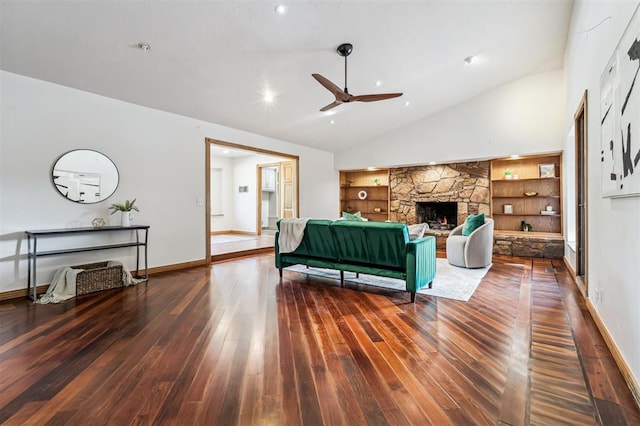 3425 Cheyenne Dr, Edmond, OK 73013 - living room with ceiling fan, hardwood / wood-style floors, built in shelves, a stone fireplace, and high vaulted ceiling