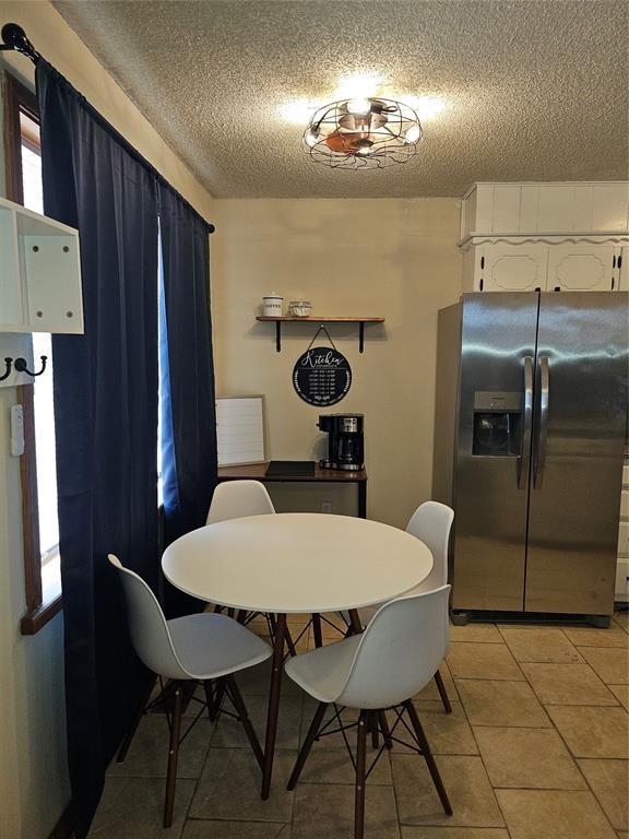 321 W 4th St, Hobart, OK 73651 - dining room featuring a textured ceiling and light tile patterned flooring