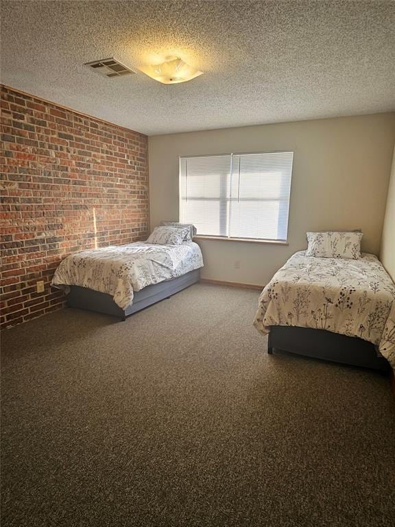 321 W 4th St, Hobart, OK 73651 - carpeted bedroom featuring brick wall and a textured ceiling