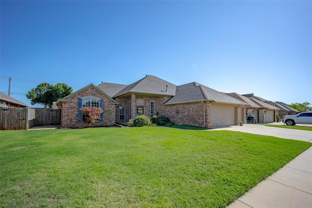 9124 SW 28th St, Oklahoma City, OK 73128 - view of front facade with driveway, an attached garage, brick siding, and roof with shingles