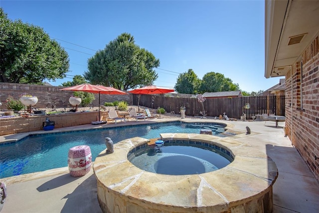 9124 SW 28th St, Oklahoma City, OK 73128 - view of pool with a fenced backyard, a pool with connected hot tub, and a patio area