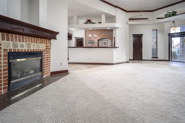 9124 SW 28th St, Oklahoma City, OK 73128 - unfurnished living room with a high ceiling, ornamental molding, a fireplace, carpet, and granite floors