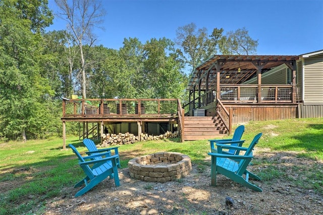 86 Crooked Oaks Ln, Broken Bow, OK 74728 - view of grassy yard featuring a fire pit, stairway, and a wooden deck