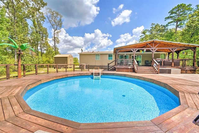 86 Crooked Oaks Ln, Broken Bow, OK 74728 - outdoor pool featuring a wooden deck and a storage unit