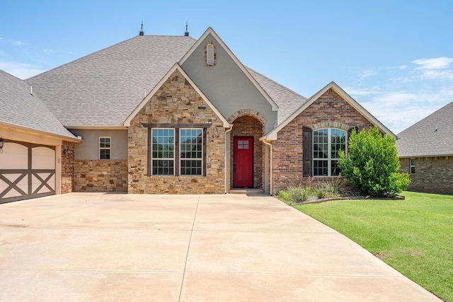 3000 Warwick Pl, Edmond, OK 73013 - view of front of house with stucco siding, stone siding, a front lawn, and a shingled roof