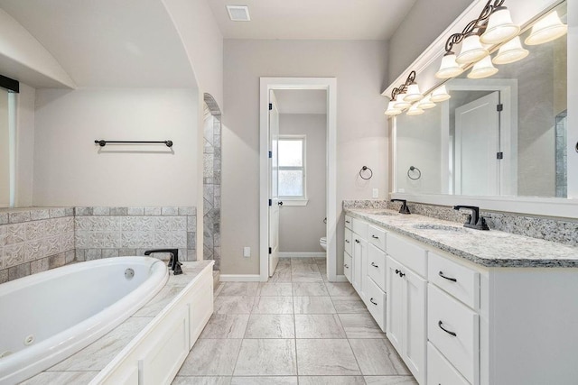 3000 Warwick Pl, Edmond, OK 73013 - full bathroom featuring a whirlpool tub, double vanity, and marble look tiles
