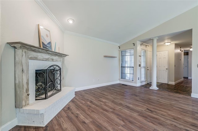 16408 Del Mar Dr, Edmond, OK 73013 - unfurnished living room featuring decorative columns, wood finished floors, vaulted ceiling, ornamental molding, and a fireplace