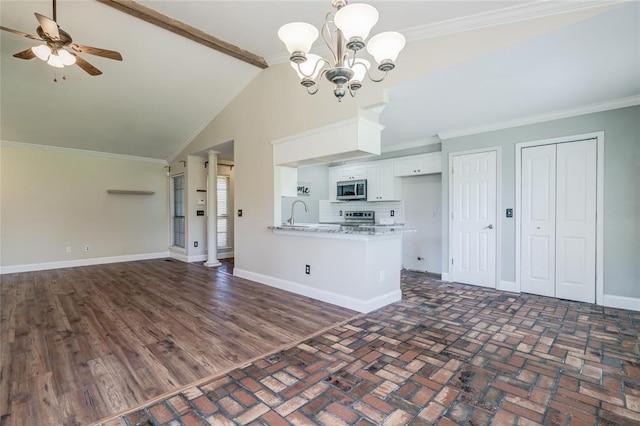 16408 Del Mar Dr, Edmond, OK 73013 - unfurnished living room featuring a chandelier, lofted ceiling, ceiling fan, and ornamental molding
