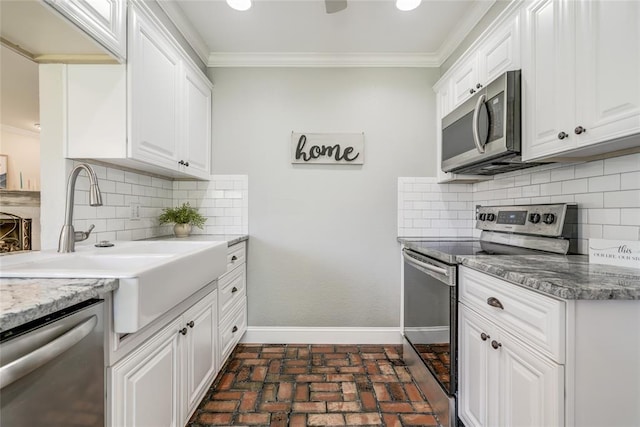 16408 Del Mar Dr, Edmond, OK 73013 - kitchen featuring stainless steel appliances, crown molding, brick floors, white cabinets, and backsplash