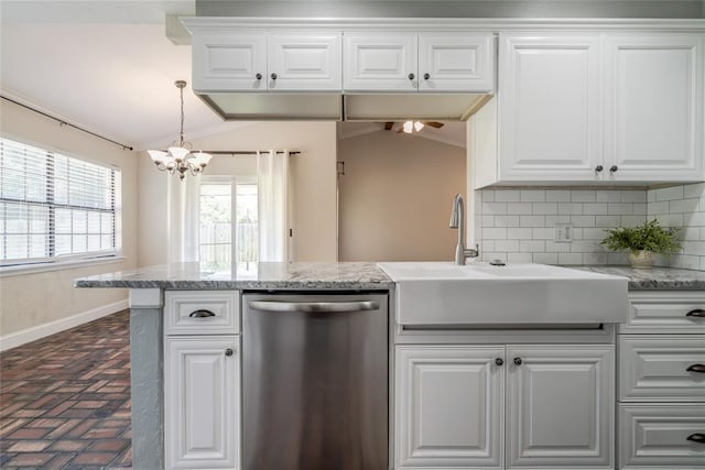 16408 Del Mar Dr, Edmond, OK 73013 - kitchen with stainless steel dishwasher, brick flooring, a chandelier, vaulted ceiling, and backsplash