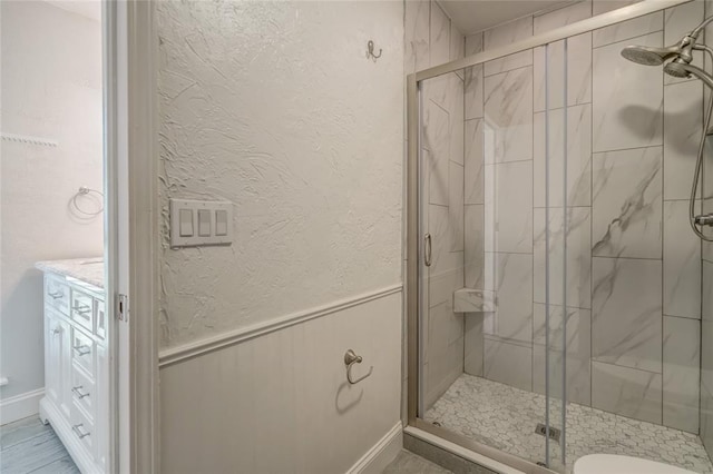 16408 Del Mar Dr, Edmond, OK 73013 - bathroom featuring a stall shower and wainscoting
