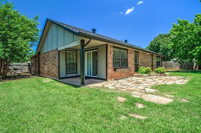 16408 Del Mar Dr, Edmond, OK 73013 - rear view of house featuring a patio area, brick siding, and board and batten siding