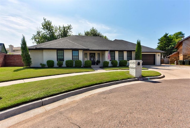 1001 Fountain Gate Cir, Norman, OK 73072 - ranch-style home with a garage, driveway, roof with shingles, and brick siding