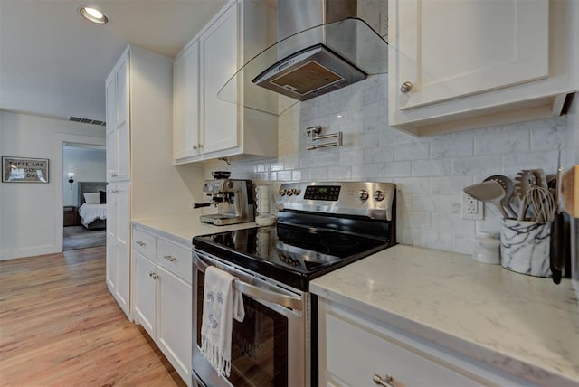 1001 Fountain Gate Cir, Norman, OK 73072 - kitchen with electric stove, wall chimney exhaust hood, white cabinets, light stone countertops, and recessed lighting