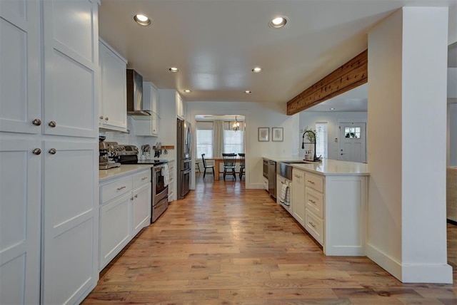 1001 Fountain Gate Cir, Norman, OK 73072 - kitchen featuring appliances with stainless steel finishes, wall chimney exhaust hood, light wood-style flooring, recessed lighting, and light countertops