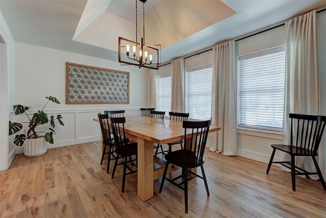 1001 Fountain Gate Cir, Norman, OK 73072 - dining space with a chandelier, healthy amount of natural light, light wood-style floors, and a decorative wall