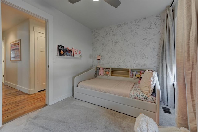 1001 Fountain Gate Cir, Norman, OK 73072 - bedroom featuring carpet flooring, a ceiling fan, and wood finished floors