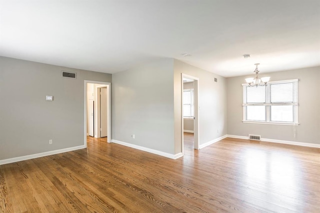 3020 NW 71st St, Oklahoma City, OK 73116 - spare room with a chandelier and wood finished floors