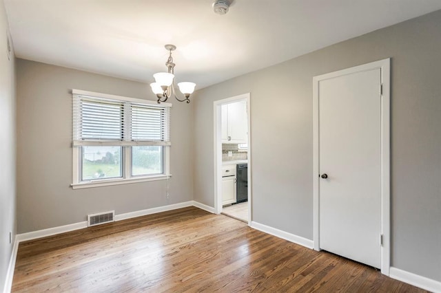 3020 NW 71st St, Oklahoma City, OK 73116 - empty room with a chandelier, light wood-style floors, and a smoke detector