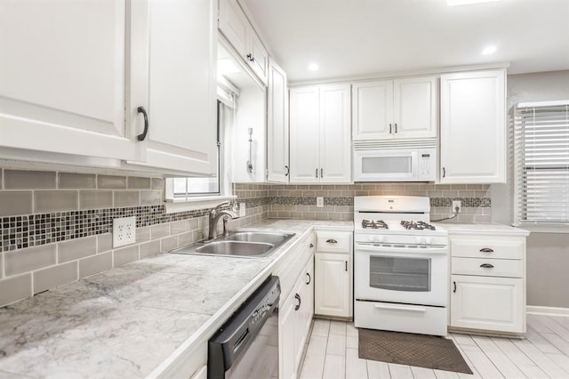 3020 NW 71st St, Oklahoma City, OK 73116 - kitchen with white appliances, white cabinets, light countertops, decorative backsplash, and recessed lighting